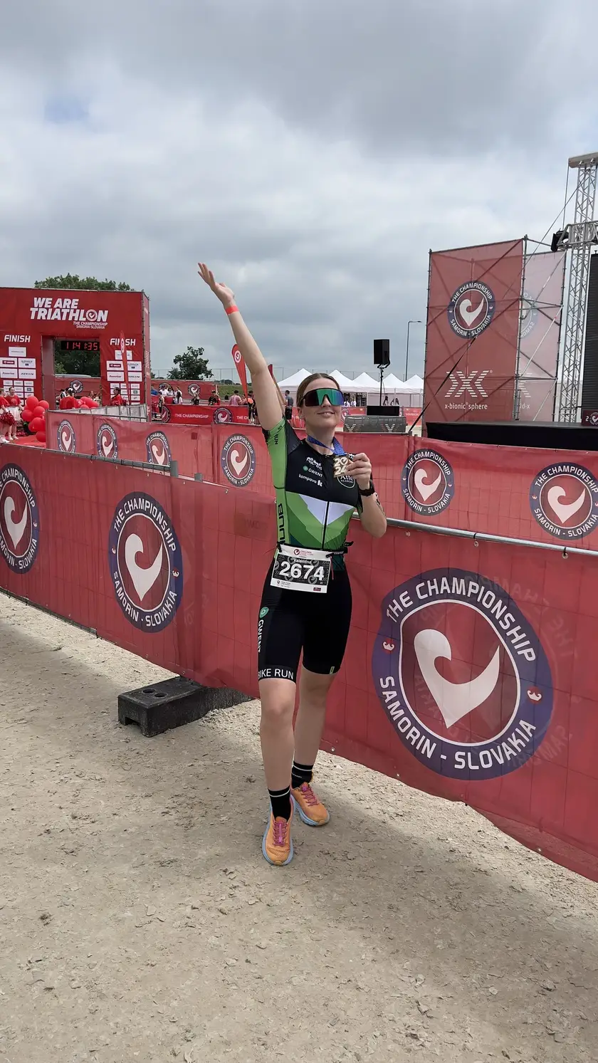 Atte ACADEMY athlete raising an arm in celebration at a race in Šamorín
